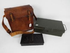 A World War Two (WWII / WW2) type leather despatch or ammunition bag and two vintage cash tins.