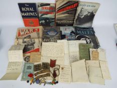 A collection of vintage military ephemera, cap badge and similar.