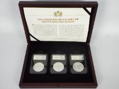 The Complete Peace Dollar Mintmark Collection set by CPM comprising three encapsulated Peace
