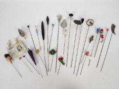 A varied collection of vintage hat and veil pins.