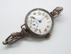 A silver cased wristwatch with Arabic numerals and subsidiary seconds dial,