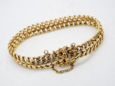 A hallmarked 9 carat gold bracelet with safety chain to the clasp, approx 18.
