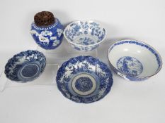 A collection of Chinese blue and white ceramics comprising four bowls and a ginger jar,