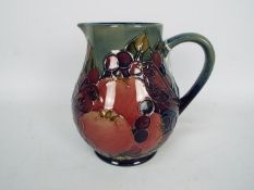 Moorcroft - A Moorcroft Pottery jug decorated in the Finches And Fruit pattern,