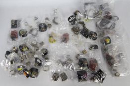 Costume Jewellery - ten bags containing unused costume jewellery on tags to include rings, dog tags,