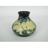 Moorcroft - A miniature Moorcroft Pottery vase decorated in the Nivalis pattern, approximately 5.