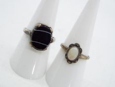 Two silver stone set dress rings,