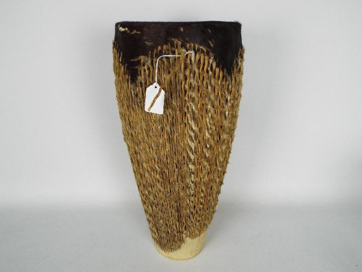 An animal skin tribal drum, 48 cm (h).