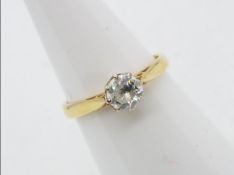 A yellow metal single stone diamond ring, approximately 0.