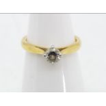 A hallmarked 18 carat yellow and white gold diamond solitaire ring, approximately .