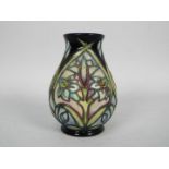 Moorcroft - A small Moorcroft Pottery vase decorated in the Cleopatra pattern, approximately 9.