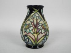 Moorcroft - A small Moorcroft Pottery vase decorated in the Cleopatra pattern, approximately 9.