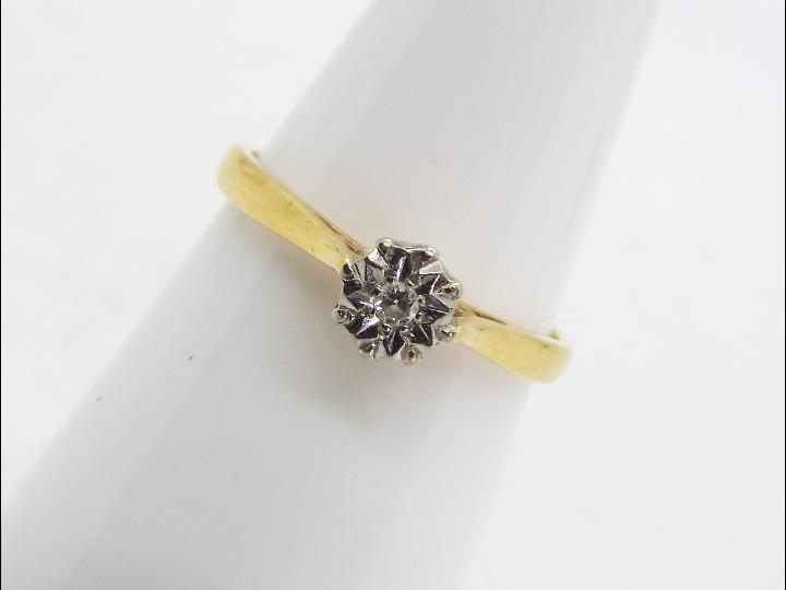 A hallmarked 18 carat yellow and white gold illusion set single stone diamond ring,