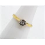 A hallmarked 18 carat yellow and white gold illusion set single stone diamond ring,