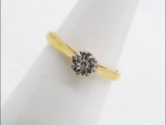 A hallmarked 18 carat yellow and white gold illusion set single stone diamond ring,