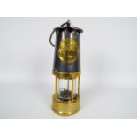A Protector Lamp & Lighting Co Type MC40 safety lamp.