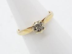 A 9 carat yellow gold cluster ring, the crown set with four 5-point stones, size K+½, approx 1.