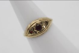 A lady's hallmarked 9 carat gold ring set with three garnets, approx 1.