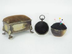 Pin Cushions - A silver plated pin cushion box raised on four supports,