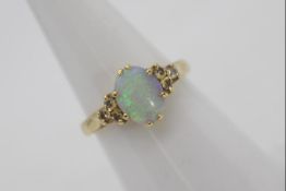 An 18ct gold, opal and diamond ring,