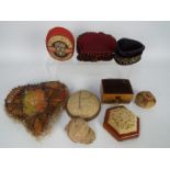 A collection of early 20th century and later pin cushions to include a heart shaped material