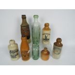 A collection of vintage stoneware and glass bottles to include Britannia Brewing Co Liverpool,