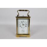 A good French brass and glass Corniche styled case striking carriage clock with alarm,