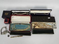 A collection of costume jewellery, pearls, jewellery boxes, small silver locket and similar.