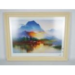 A large framed Oriental print depicting a riverside scene with mountainous background,