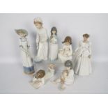 A collection of Nao figurines, children and ladies, largest approximately 32 cm (h).