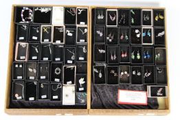 Costume Jewellery - two display cases containing a quantity of hand made earrings with sterling
