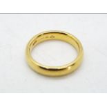 A hallmarked 18 carat gold wedding ring, size J+½, approx 5.