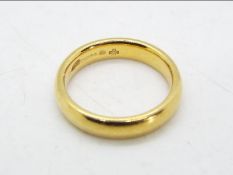 A hallmarked 18 carat gold wedding ring, size J+½, approx 5.