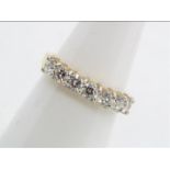 An 18ct yellow gold diamond set half eternity ring, approximately 70 points, size K,