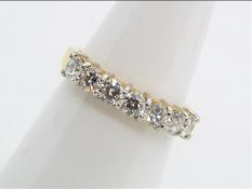 An 18ct yellow gold diamond set half eternity ring, approximately 70 points, size K,