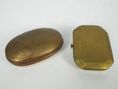 A Victorian copper snuff box of oval form and a brass example.