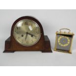 An oak cased mantel clock with carved decoration and one other.