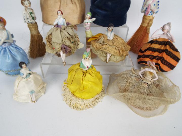 A collection of early 20th century porcelain half doll pin cushions and half doll crumb brushes. - Image 5 of 5