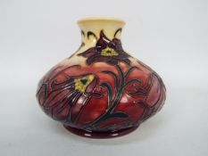 Moorcroft - A Moorcroft Pottery vase of squat form, decorated in the Pasque Flower pattern,