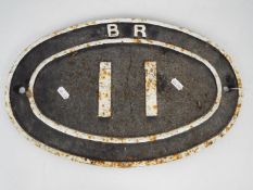 Railwayana - A vintage British Rail, cast iron oval bridge plate 11, approximately 28.5 cm x 45 cm.