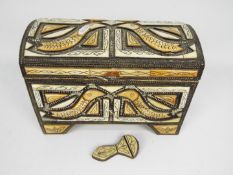 A metal clad casket with inlaid decoration and twin handles, approximately 21 cm x 32 cm x 18 cm.