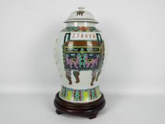 A large Chinese vase and cover decorated with vase, censers,