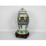 A large Chinese vase and cover decorated with vase, censers,