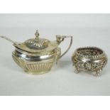A late Victorian silver mustard pot with gadrooned decoration, hinged lid and blue glass liner,