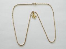 An 18 carat gold pendant and 9 carat gold chain, the chain measuring approx 51 cm,