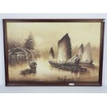 A large framed oil on board depicting Asian boats on a river by a riverside village,