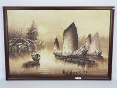 A large framed oil on board depicting Asian boats on a river by a riverside village,