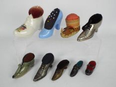 A quantity of shoe or boot form pin cushions to include ceramic, treen,