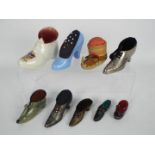 A quantity of shoe or boot form pin cushions to include ceramic, treen,