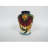 Moorcroft - A small Moorcroft Pottery vase decorated in the Anna Lily pattern, dated '98,